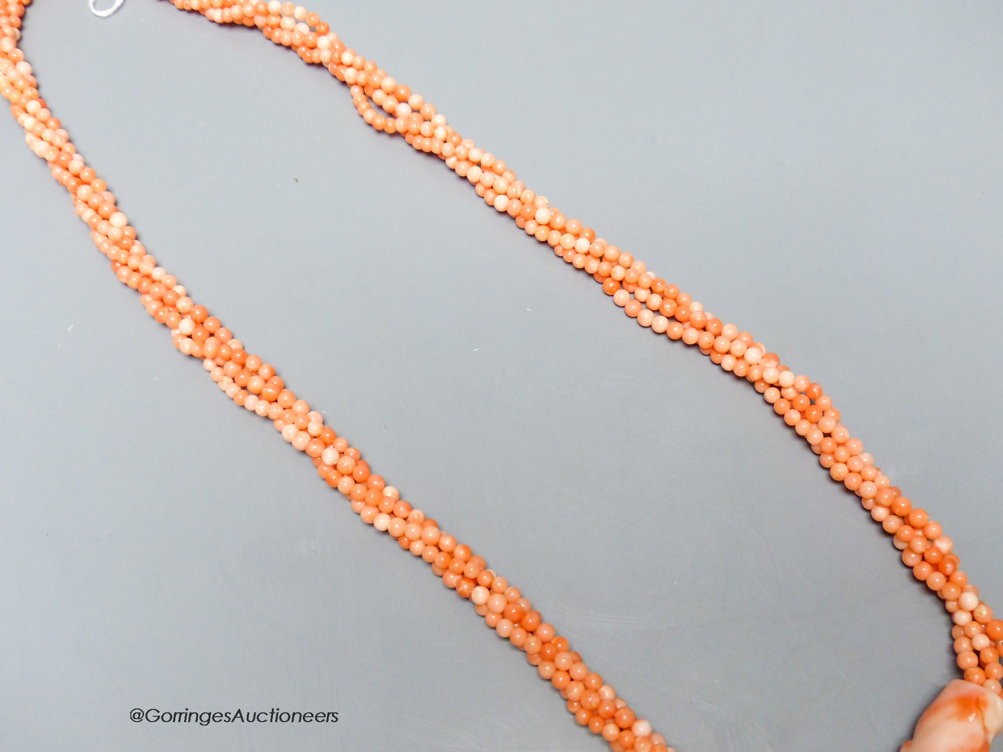 A modern twisted quadruple strand coral bead necklace, 78cm.